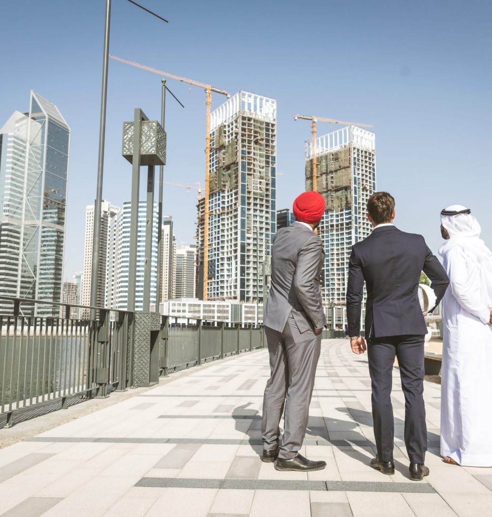 Multiethnic business team meeting outdoors - Three businessmen talking about business on a formal meeting